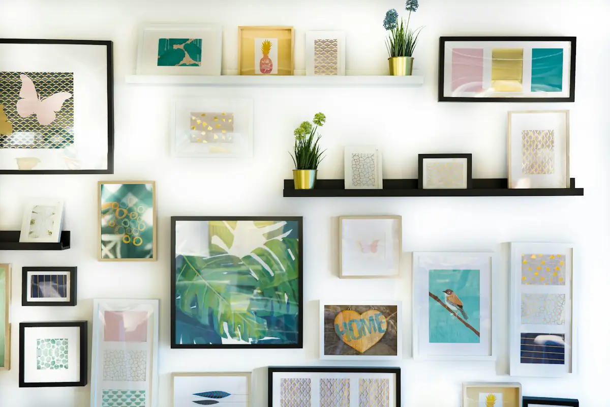 Bright wall arranged with framed prints, shelves, and small plants