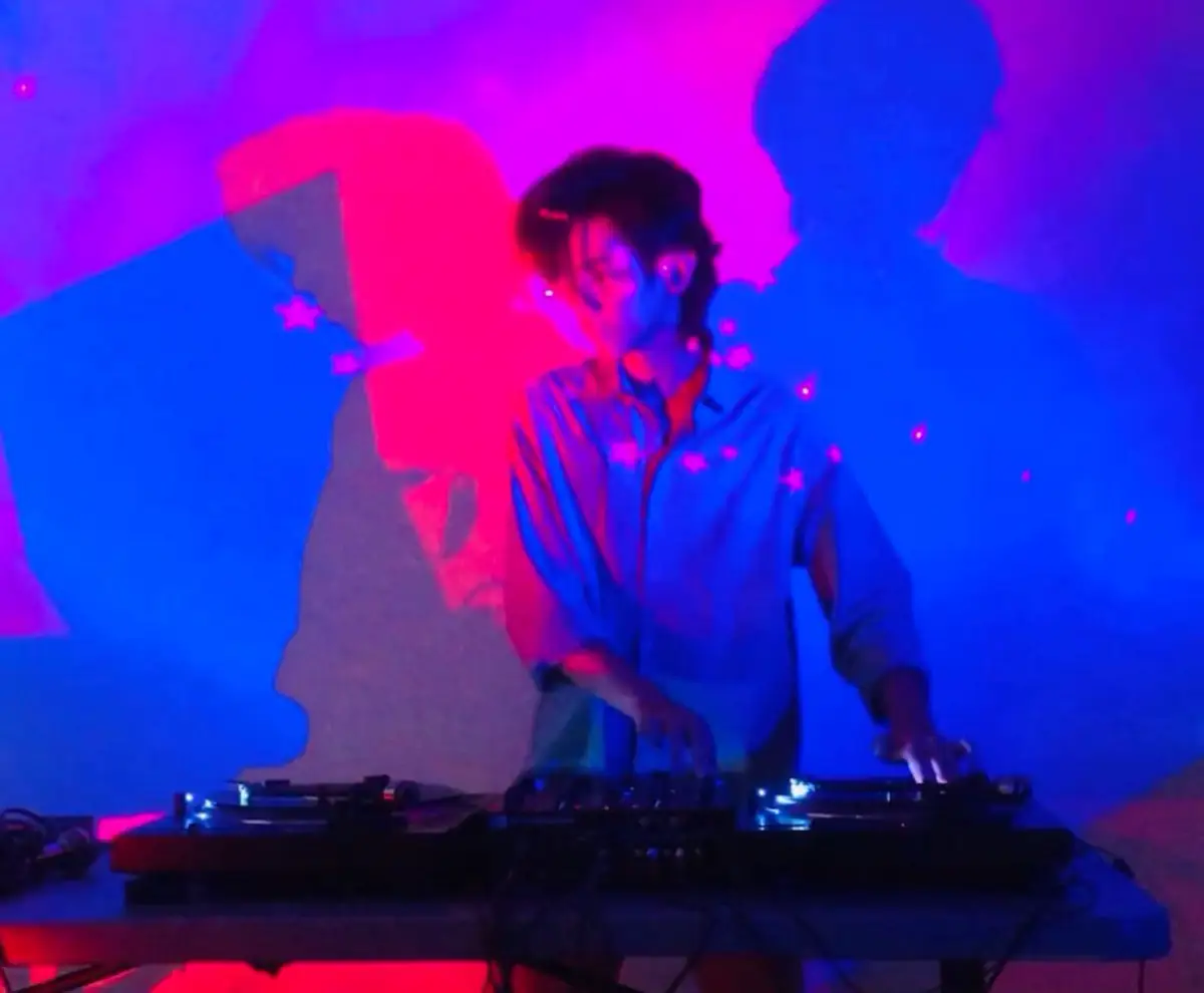 DJ AnthonyB performing at a pair of turntables